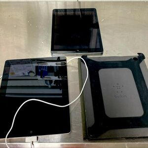 Two IPads, one charger, one case
